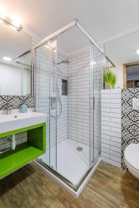 a bathroom with a glass shower and a sink at Artkazal in Mórahalom