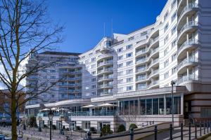 a large white building with windows in front of it at The Chelsea Harbour Hotel & Spa London in London