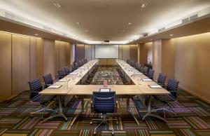 a large conference room with long tables and chairs at Shama Lakeview Asoke Bangkok in Bangkok