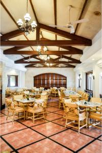 a dining room with wooden tables and chairs at The Lagoona Resort in Lonavala