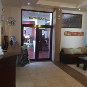 a restaurant entrance with a sign on the door at Stenata Huge Ski To Door Apartments in Pamporovo
