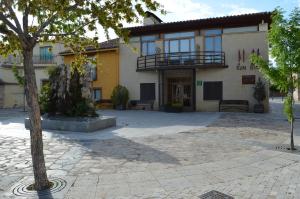 a building with a tree in front of it at Hotel Rural Luna Llena in Torremocha de Jarama