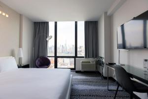 a hotel room with a bed and a large window at Z NYC Hotel in Queens +19 photos