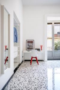 una camera con scrivania bianca e sgabello rosso di mrg home holiday a Sorrento