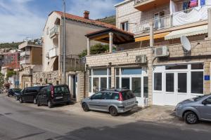 a group of cars parked in front of a building at Apartment Jasmina in Dubrovnik