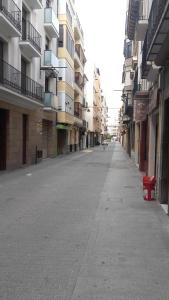 an empty street in a city with tall buildings at Hospederia Gomis 26 in Ontinyent