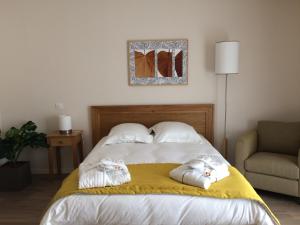 a bedroom with a bed with two towels on it at Domitys - Le Castel Du Val in Pérignat-lès-Sarliève +18 photos