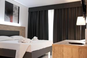 Postel nebo postele na pokoji v ubytování Ambruosi Village Resort & SPA
