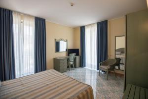 a hotel room with a bed and a desk at Hotel Villa Maria in Sorrento