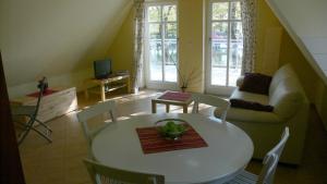 a living room with a table and a couch at Haus Am Strom 50 in Warnemünde