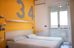 A bed or beds in a room at Hotel Morfeo - Young People Hotels