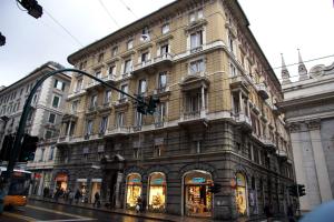 a large building on a city street with a traffic light at Hotel Bel Soggiorno in Genova