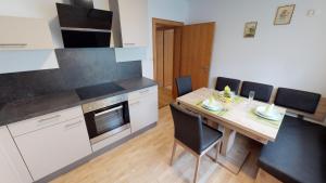 a kitchen with a wooden table and a dining room at Ferienwohnung Pirker in Spittal an der Drau