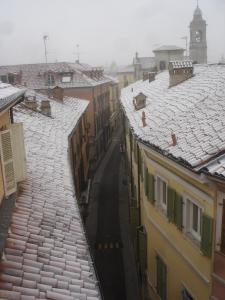 Blick auf eine Stadt mit schneebedeckten Dächern in der Unterkunft Albergo Residence Perosi in Tortona