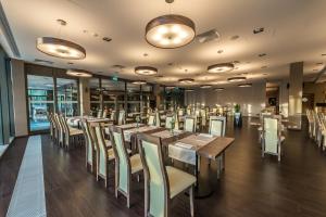 a dining room with wooden tables and chairs at APART HOTEL 12 in Rzeszów
