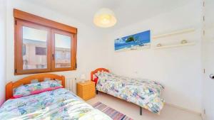 a bedroom with a bed and a window at La Mata Beach Apartment in La Mata