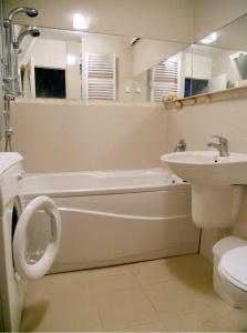 a bathroom with a sink and a tub and a toilet at Apartment Spacious Liman in Novi Sad