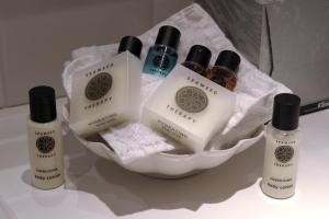 a group of bottles of soap and towels in a bowl at Holiday Inn - Glasgow Airport by IHG in Paisley