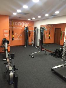 a gym with cardio equipment in a room with orange walls at Absolute Hotel Limerick in Limerick