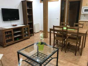 a living room with a table and a dining room at Antequeruela Tourists Home in Toledo