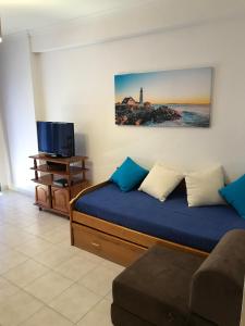 アルマカオ・デ・ペラにあるEdificio Canoaのベッドルーム(ベッド1台、テレビ、ソファ付)