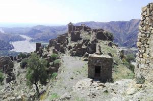 an old building on the side of a mountain at Oikos in Condofuri