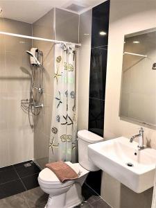 a bathroom with a toilet and a sink at Izen Plus Budget Hotel & Residence in Rayong