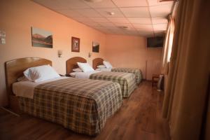 A bed or beds in a room at Hotel Prisma Cusco