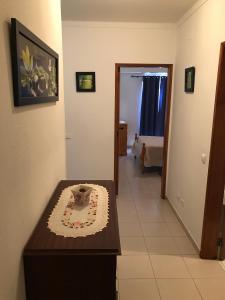 a room with a table with a cake on it at Caravela B in Armação de Pêra +6 photos