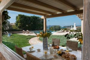 una mesa con comida en el patio en Villa Emerald, en Porto Heli