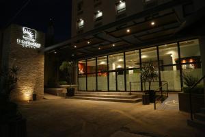 a building with a sign on the front of it at night at Hotel El Sembrador in Guasave