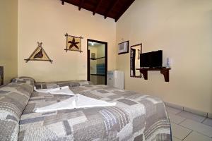 A bed or beds in a room at Pousada Morada da Praia