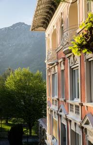 a building with a mountain in the background at Hotel Erika in Bad Reichenhall