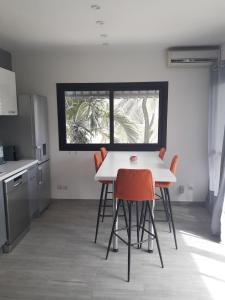 a kitchen with a table and chairs and a window at Studio Sunshine in Saly Portudal