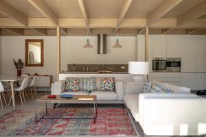 a living room with a couch and a table at Pestana Troia Eco-Resort & Residences in Troia
