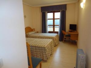 Postel nebo postele na pokoji v ubytování Hotel Silos 2000