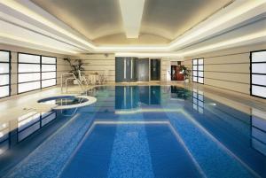 
a large swimming pool in a hotel room at Hotel Principe Di Savoia - Dorchester Collection in Milan
