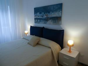a bedroom with a bed with two lamps on it at Isola Di Man in Imperia