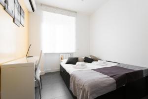 a small bedroom with a bed and a window at Casa Paestum. Your wonderful garden in Rome in Rome