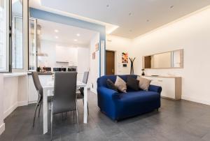 a living room with a blue couch and a table at Casa Paestum. Your wonderful garden in Rome in Rome