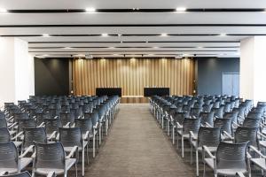 an empty lecture hall with chairs and podiums at Ceiba Hotel Bissau in Bissau +41 photos