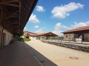 a building with a walkway in front of it at Allgäu Meadow Ranch in Hergatz