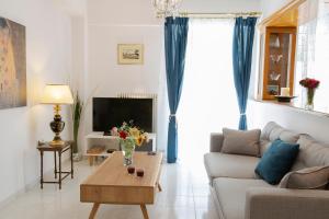 a living room with a couch and a table at Zeas Apartment in Piraeus