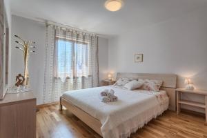Postel nebo postele na pokoji v ubytování Apartments Vlasta