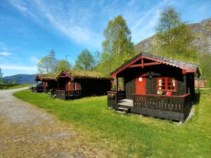 a couple of small buildings with grass roofs at Vistdal Camping in Myklebostad