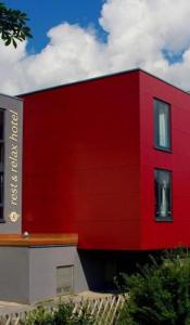 a red building with a red wall at Von Korff´S Rest & Relax Hotel in Meschede