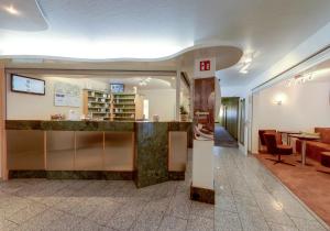 a lobby of a building with a bar in it at Apartmenthotel Residenz Steinenbronn in Steinenbronn