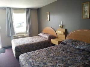Postel nebo postele na pokoji v ubytování Aries Motel