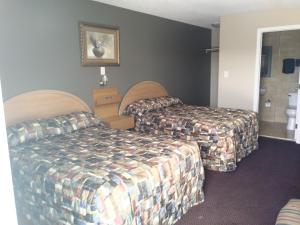 Postel nebo postele na pokoji v ubytování Aries Motel