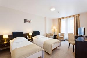 Posteľ alebo postele v izbe v ubytovaní Qubus Hotel Wrocław